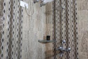 a shower with a shower head in a bathroom at Hotel Dior Near Jal Mahal, Jaipur in Jaipur