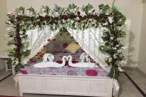 a bed with two swans in a tent at Hotel Dior Near Jal Mahal, Jaipur in Jaipur
