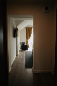 a hallway with a living room with a couch and a window at Vila Slavonika in Slavonski Brod