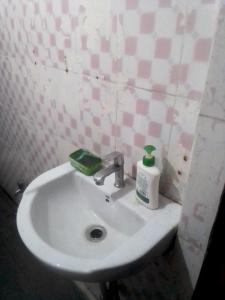 a bathroom sink with a bottle of soap on it at Himalayan Mountain Triund Hill Trekkers and Waterfalls View Hostel in McLeod Ganj