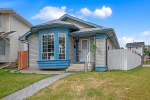 a small house with a blue front door at 33 Executive Home, Ac, Airport in Calgary