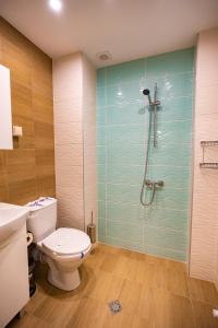 a bathroom with a toilet and a glass shower at Hotel Sveti Vasilii Veliki in Gabrovo