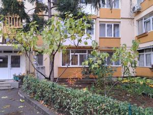 an apartment building with trees in front of it at Mia Apartments in Craiova
