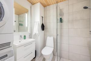 a bathroom with a toilet and a shower at Penthouse Valsa in Rovaniemi +21 photos