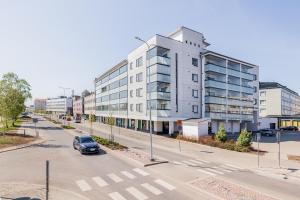a car parked in front of a building on a street at Penthouse Valsa in Rovaniemi