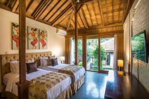 Ένα ή περισσότερα κρεβάτια σε δωμάτιο στο Villa Lumbini - Cozy and Spacious Villa in Ubud