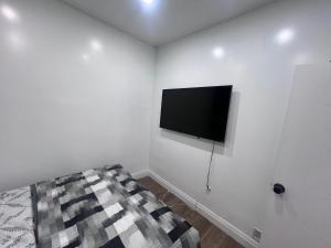 a white room with a flat screen tv on the wall at Private Bathroom Room In Cambridge B7 in Cambridge
