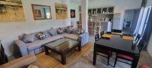 a living room with a couch and a table and a piano at city garden Kech in Marrakech