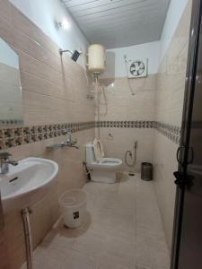 a bathroom with a toilet and a sink at The dreamcatcher by lake & woods in Bhīm Tāl