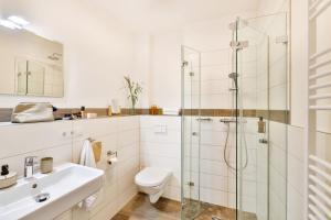 a bathroom with a shower and a toilet and a sink at Apartments an Sankt Marien in Stralsund +52 photos