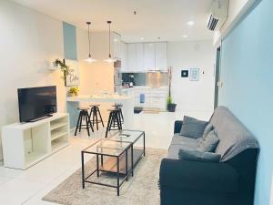 a living room with a couch and a table at Mercu Summer Suites Kuala Lumpur Bukit Bintang By Classy in Kuala Lumpur