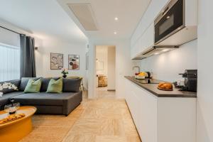 a living room with a couch and a kitchen at Sweett - Mazzini in Milan