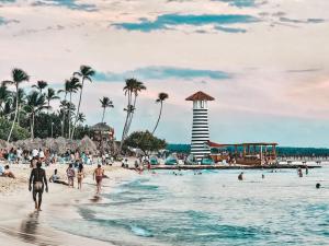 a group of people on a beach with a lighthouse at Luxury Apartment IZHA 202 in La Laguna