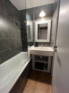 a bathroom with a sink and a bath tub at Studio 4 personnes Plein Centre in LʼHuez