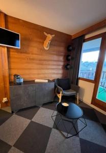 a living room with a couch and a chair at Studio 4 personnes Plein Centre in LʼHuez +11 photos