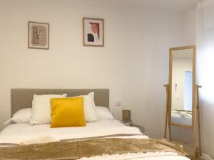 Dormitorio con cama con almohada amarilla en TAYP San Marcos 101, en Talayuela