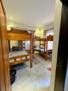 a room with three bunk beds in a room at Moshi Epic Accommodation in Moshi