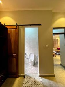 a bathroom with a toilet in a room at Moshi Epic Accommodation in Moshi +47 photos