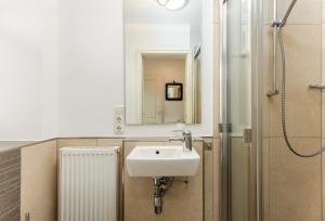 a bathroom with a sink and a shower at Sonnenfreude in Westerland +24 photos