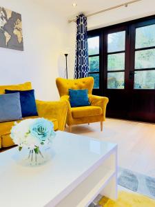 a living room with a couch and a table at Fairy Meadows Hideaway in Peterborough