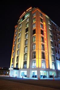 a hotel building with a lit up sign on it at Gevher Hotel in Kayseri