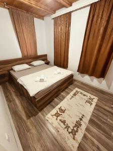 a bedroom with a large bed and a rug at Pool & Rest Holiday Home 3D in Bihać
