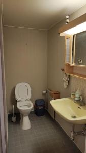 a bathroom with a toilet and a sink at nice apartment in Viby in Sollentuna +15 photos