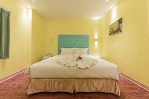 Ένα ή περισσότερα κρεβάτια σε δωμάτιο στο Lion King Hotel