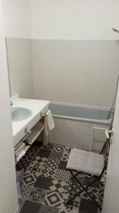 a bathroom with a sink and a tub and a mirror at 3-7 Centre Ville in Montauban