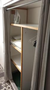 an empty refrigerator with its door open and a curtain at 3-7 Centre Ville in Montauban