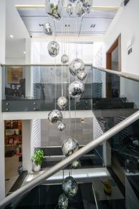 a chandelier hanging from a staircase in a house at Nội homestay in Hue