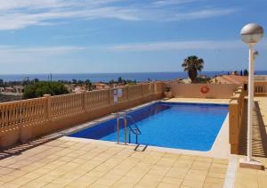 a swimming pool on the balcony of a house at Casa Luna - Sea view apartment Bolnuevo in Bolnuevo