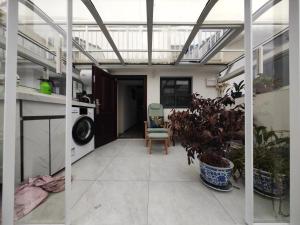 a room with a washing machine and a chair at 江南民居 in Suzhou