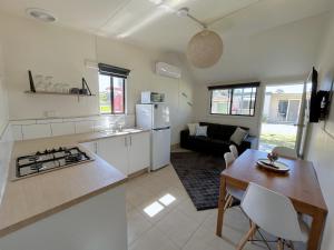 a kitchen and living room with a table and a stove at Mandurah Coastal Holiday Park in Mandurah