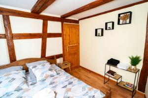 a bedroom with a bed in a room with wooden ceilings at Refuge des Vignerons - Turckheim in Turckheim +35 photos