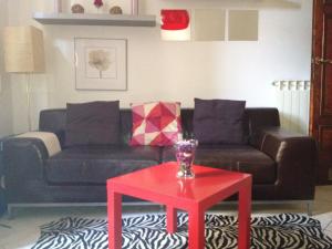 a living room with a couch and a red table at Apartment With Garden in Lucca