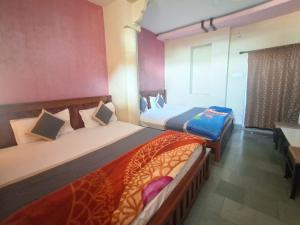 Voodi või voodid majutusasutuse Hotel Om Pushkar toas
