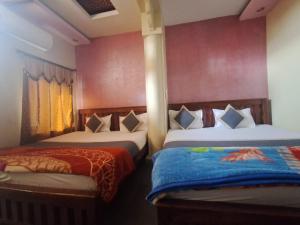 Voodi või voodid majutusasutuse Hotel Om Pushkar toas