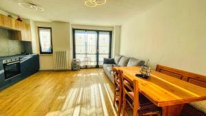 a living room with a couch and a table at Appartamento Richardette - Affitti Brevi Italia in Sauze dʼOulx