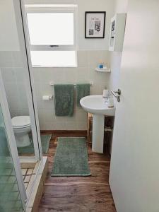 a bathroom with a sink and a toilet at Tus Nua in Langebaan