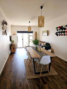 a living room with a table and a couch at Tus Nua in Langebaan