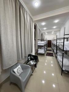 a room with four bunk beds and a chair at Velvet Vouge Hostel N2 in Yerevan