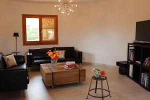 a living room with a couch and a coffee table at Villa Torre al Mar in Cala Santanyi