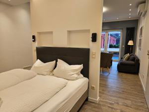 a bedroom with a bed and a living room at Appartement Vermietung Brunner in Rostock
