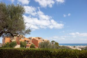 a group of houses with the ocean in the background at Dia Apartments in Hersonissos