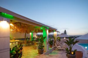 a hotel patio with a pool and tables and chairs at Dia Apartments in Hersonissos
