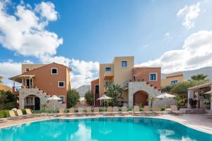a swimming pool in front of a villa at Dia Apartments in Hersonissos