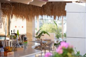 a restaurant with a counter with tables and chairs at Dia Apartments in Hersonissos