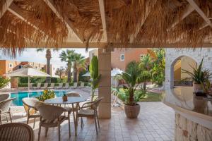 a patio with a table and chairs and a pool at Dia Apartments in Hersonissos