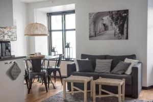 a living room with a couch and a table at Hotell Repet in Visby